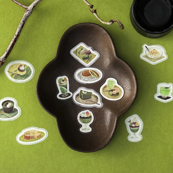 将图片加载到图库查看器,Green matcha-themed café flake sticker sheet with illustrated desserts, tea bowls and small plates accented with foil.