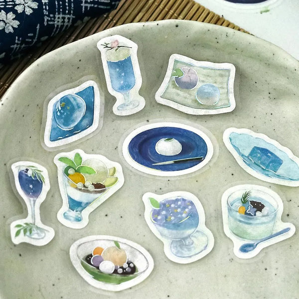 将图片加载到图库查看器,Sheet of blue-themed café flake stickers showing petite plates, parfaits, jelly desserts and drinks with shimmering foil highlights.
