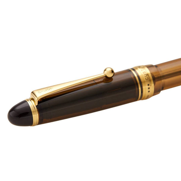 Load image into Gallery viewer, Pilot Custom 823 Fountain Pen in transparent amber brown resin with gold trim and 14K gold nib, featuring vacuum ink filling system – ideal for extended writing with elegance and precision.