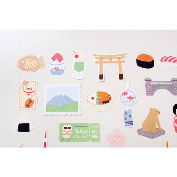 Load image into Gallery viewer, Suatelier Sticker – Tokyo Travel Diary featuring 28 illustrated Tokyo motifs such as landmarks, street food, and city scenes on a 15×17 cm coated paper sheet.