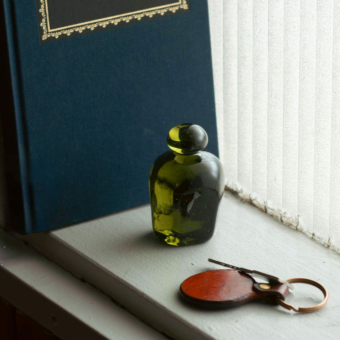 Discover the Attaché Recycled Glass Paperweight made from repurposed sake bottles in rich natural hues. A sustainable, handcrafted piece of Japanese glass art.