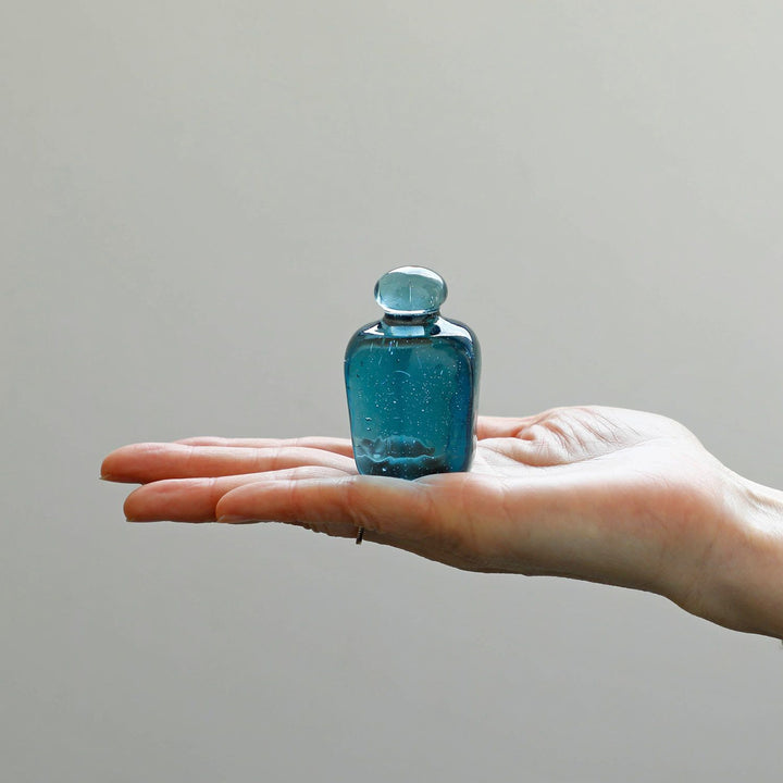 Attaché Recycled Glass Paperweight made from recycled soda bottle glass with a soft pale blue tint.