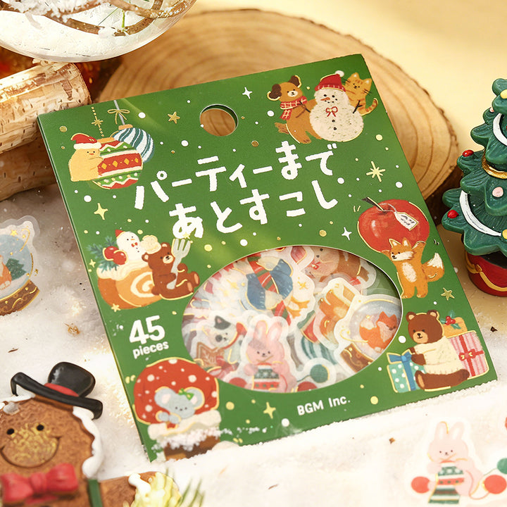 BGM Just a Little Longer Until the Party flake seal pack on a wooden slice with a mini Christmas tree