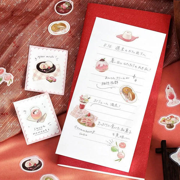 将图片加载到图库查看器，Pink-toned café flake stickers showing cakes, parfaits and delicate desserts with warm foil accents on washi paper.
