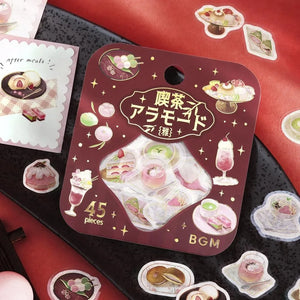 Pink-toned café flake stickers showing cakes, parfaits and delicate desserts with warm foil accents on washi paper.