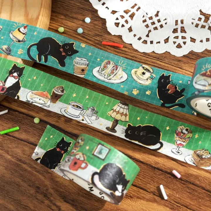 BGM Foil Stamping Masking Tape – Black Cat Café: Café Table design with black cat, sweets, drinks, and foil details on a green 20mm washi tape roll.