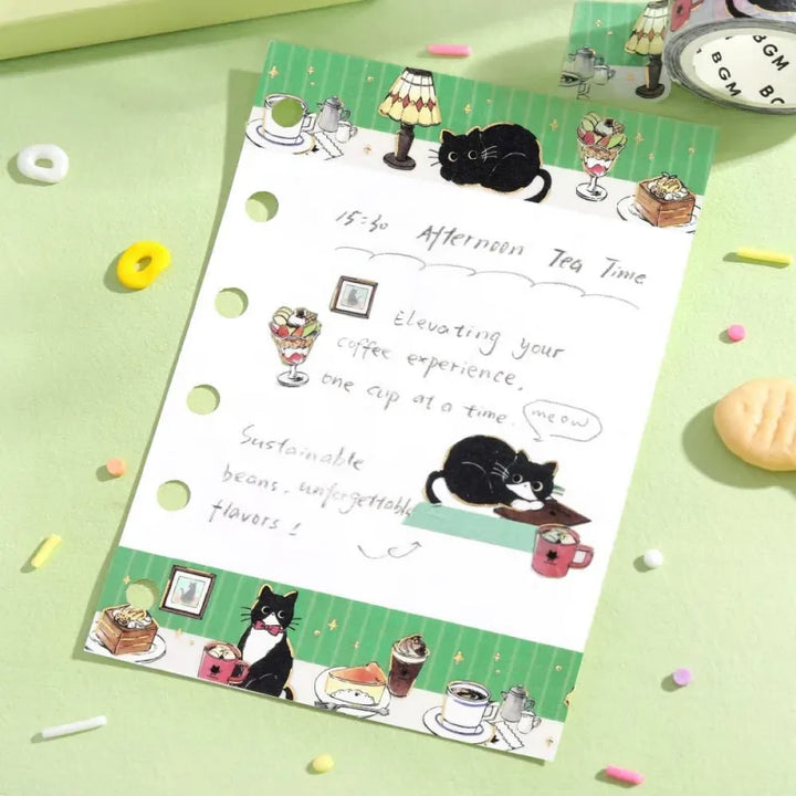 BGM Foil Stamping Masking Tape – Black Cat Café: Café Table design with black cat, sweets, drinks, and foil details on a green 20mm washi tape roll.