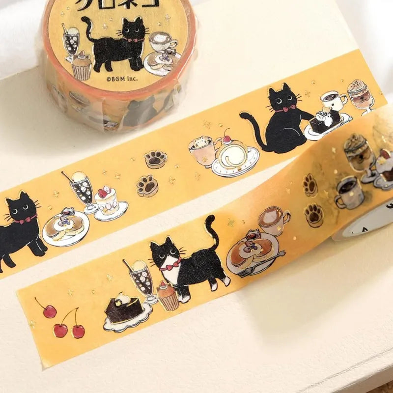 BGM Foil Stamping Masking Tape – Black Cat Café: Sweets Time design with black cats, café desserts, and pastel frames on yellow washi tape with foil accents.