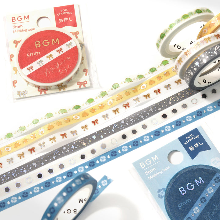A slim roll of washi tape featuring a repeating design of playful yellow chicks running, accented with metallic foil highlights—perfect for planners, journaling, and decorative crafts.