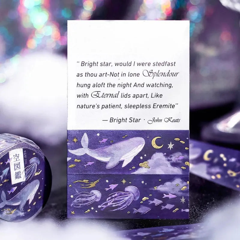 BGM Foil Stamping Masking Tape – Sky Encyclopedia: Night Calm design with whales and jellyfish in a purple starry sky, accented with gold foil moons and celestial motifs on a 20mm washi tape roll.