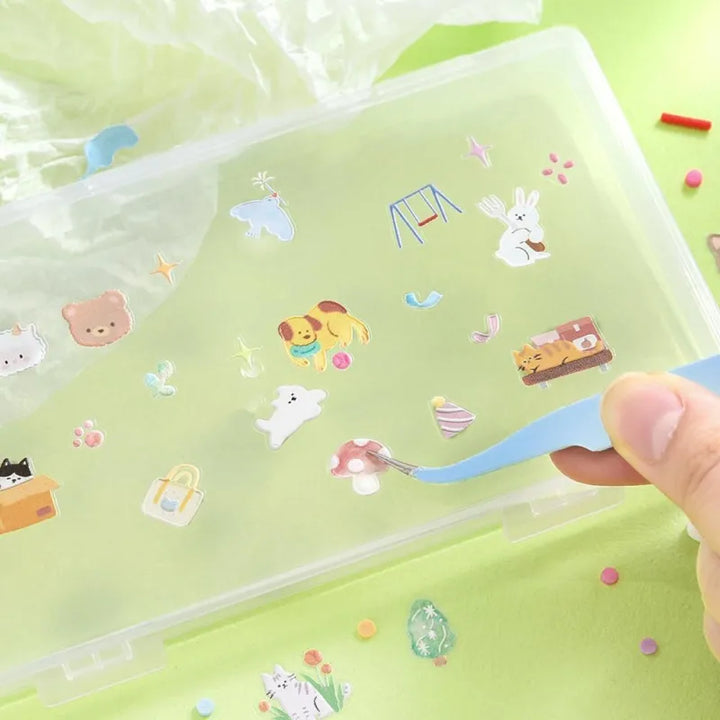 BGM Seat Seal – Animal Meets featuring one PET sticker sheet with cute animals like bears, cats, and rabbits interacting with teacups, books, and snacks. Stickers have a glossy embossed texture and playful pastel tones.