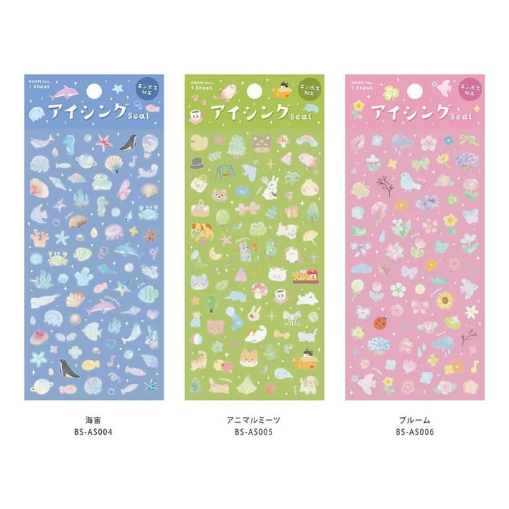 Variety of BGM Seat Seal designs, including Colorful Fruits, Soft and Fluffy Drinks, Colors of Life, Sea and Cosmos, Animal Meets, and Bloom. Each sheet features unique PET stickers with playful, textured illustrations for journaling and decorative use.