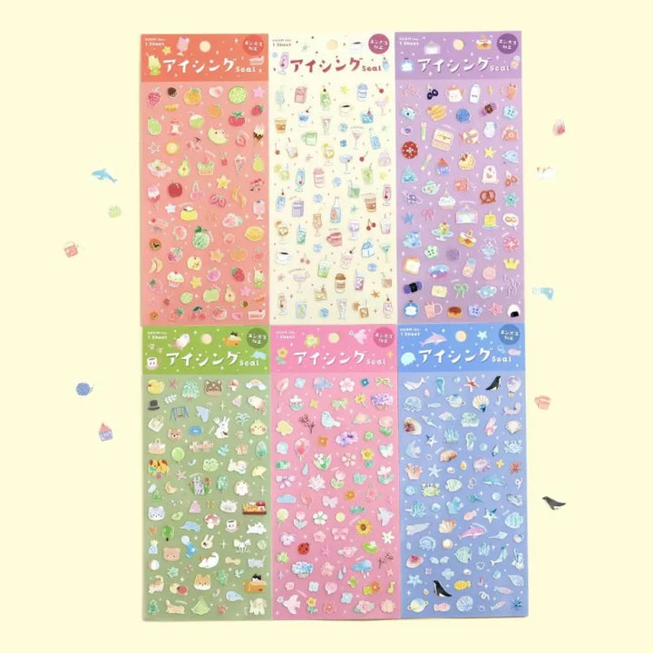 Variety of BGM Seat Seal designs, including Colorful Fruits, Soft and Fluffy Drinks, Colors of Life, Sea and Cosmos, Animal Meets, and Bloom. Each sheet features unique PET stickers with playful, textured illustrations for journaling and decorative use.
