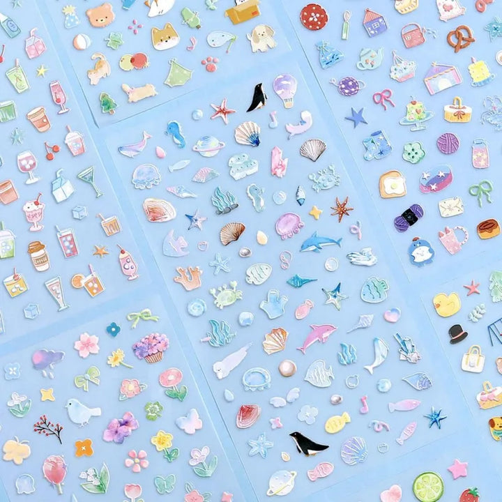 BGM Seat Seal – Ocean and Cosmos with a single PET sticker sheet featuring celestial and sea-themed icons like stars, shells, constellations, and sea creatures in pastel hues with a glossy embossed finish.