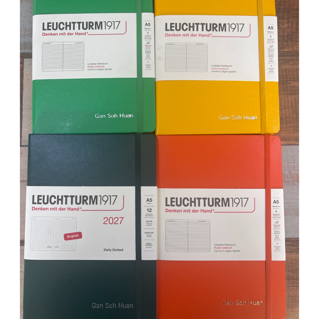 Custom Notebook Embossing – Personalised Name Silver and Copper Embossing on Leuchtturm1917 A5 Medium Hardcover Notebook in Ruled Spring Leaf, Sunshine, Pumpkin and A5 Medium Daily Planner 2027 in Dotted Forest Green at Cityluxe WorkRoom