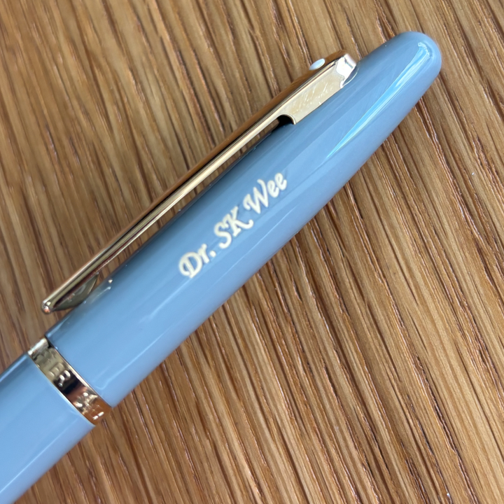 Custom Pen Engraving – Personalised Name Engraving on 
Sheaffer VFM E9427 Glossy Light Gray With PVD Gold-Tone Trim Rollerball Pen at Cityluxe WorkRoom