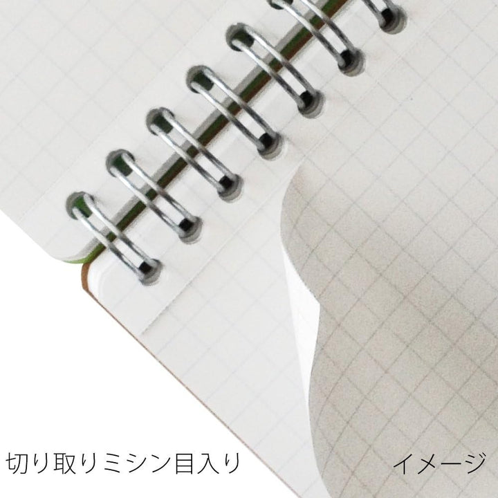 Maruman A7 memo pad with kraft cover, close-up of the twin-ring binding and tear-off perforation