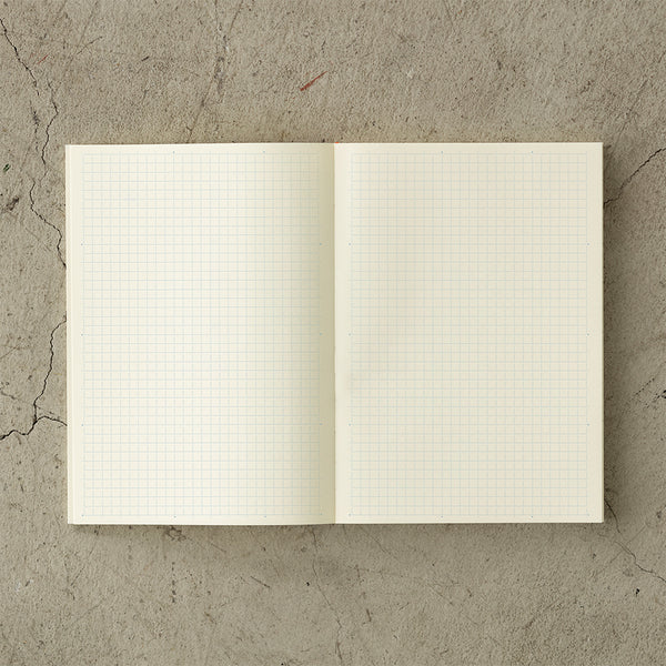 Load image into Gallery viewer, MD Notebook Diary (A5) Thin 2026 – A slim, thread-bound diary with a minimalist cream cover and glassine paper wrap, featuring monthly schedule pages, 5mm grid memo pages, and a bookmark string. Compact and lightweight, designed for portability and everyday use.
