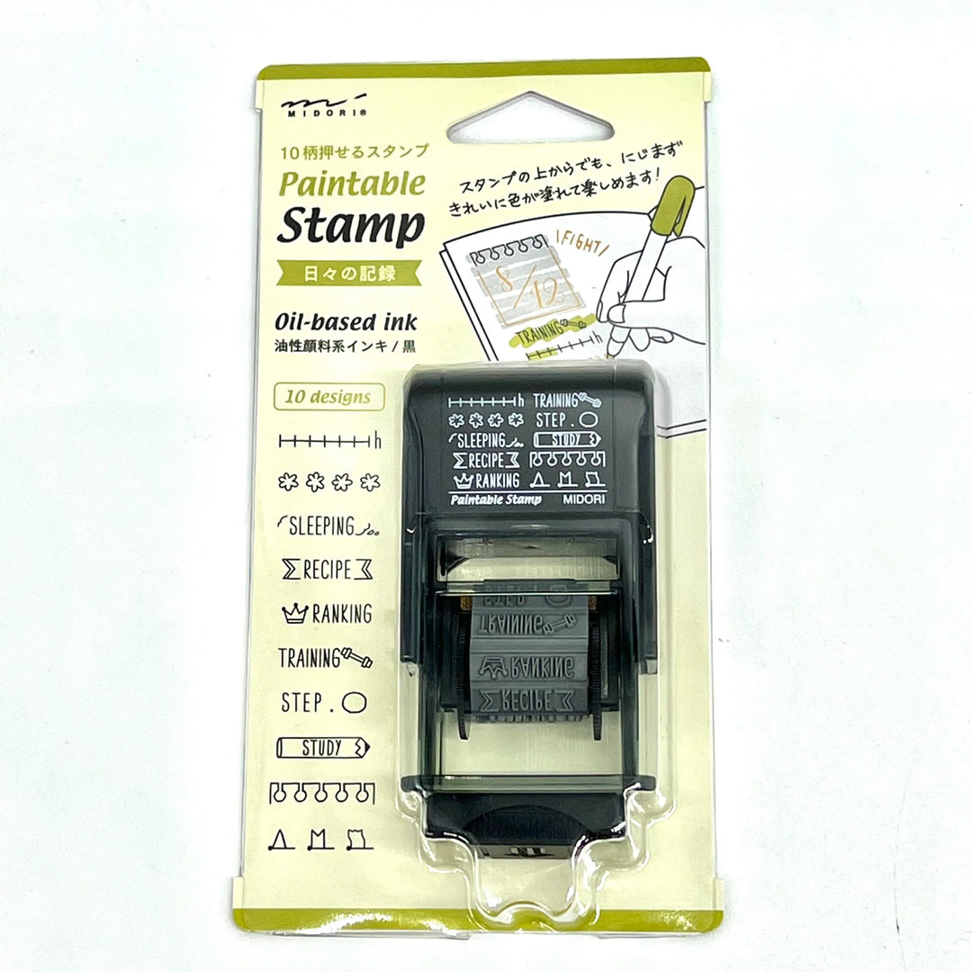 Midori Paintable Rotating Stamp Dial – Daily Life Record with rotating dial and daily activity icons, featuring a compact design and built-in black ink pad for planners and journals.