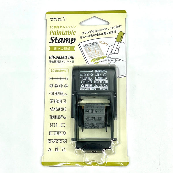 Midori Paintable Rotating Stamp Dial – Daily Life Record with rotating dial and daily activity icons, featuring a compact design and built-in black ink pad for planners and journals.