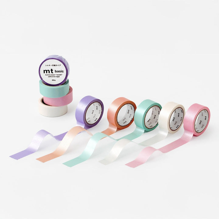 MT 1P Kamoi washi tape Silky Green roll shown with the Silky range in purple, orange, white and pink, with pearly tape strips unrolled