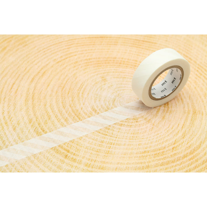 MT Deco washi tape Stripe White roll unrolled on a light wood surface