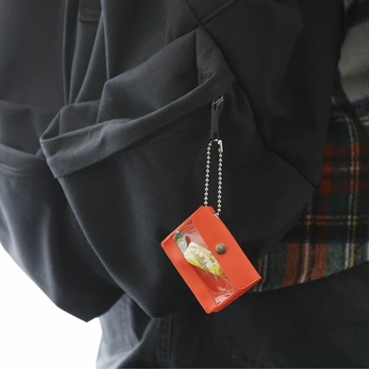 nähe General Purpose Case Mini in clear, palm-sized storage case with transparent window, back pocket, and ball chain for small items.