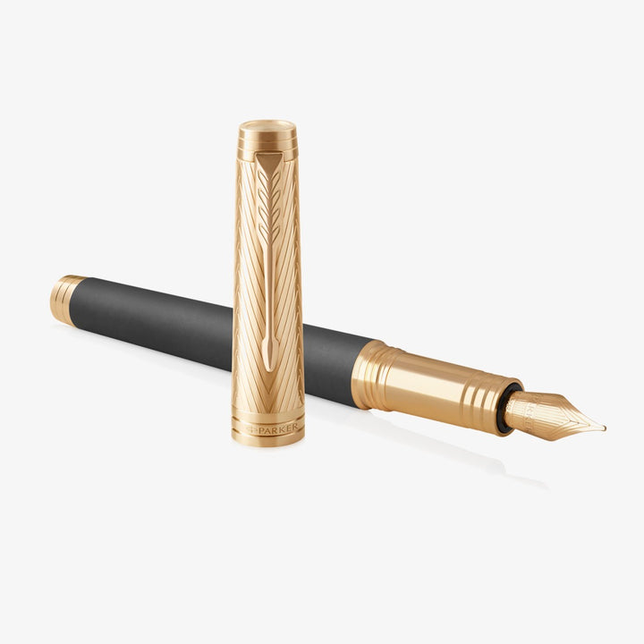Parker Premier Custom Storm Grey fountain pen uncapped, showing the gold-plated nib and cap beside it