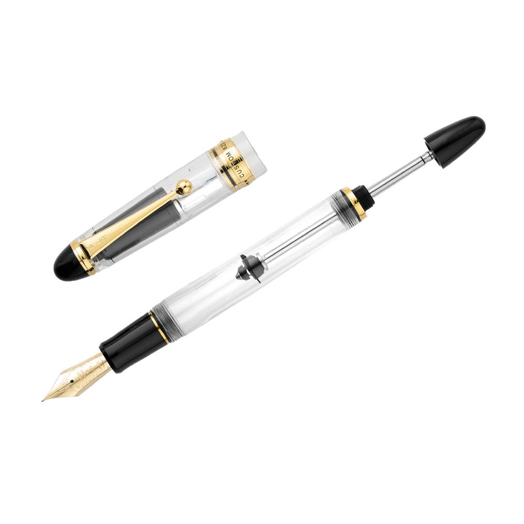 Pilot Custom 823 Fountain Pen in fully transparent clear resin with gold trim and 14K gold nib, featuring a high-capacity vacuum-filling system – perfect for showcasing ink flow and craftsmanship.