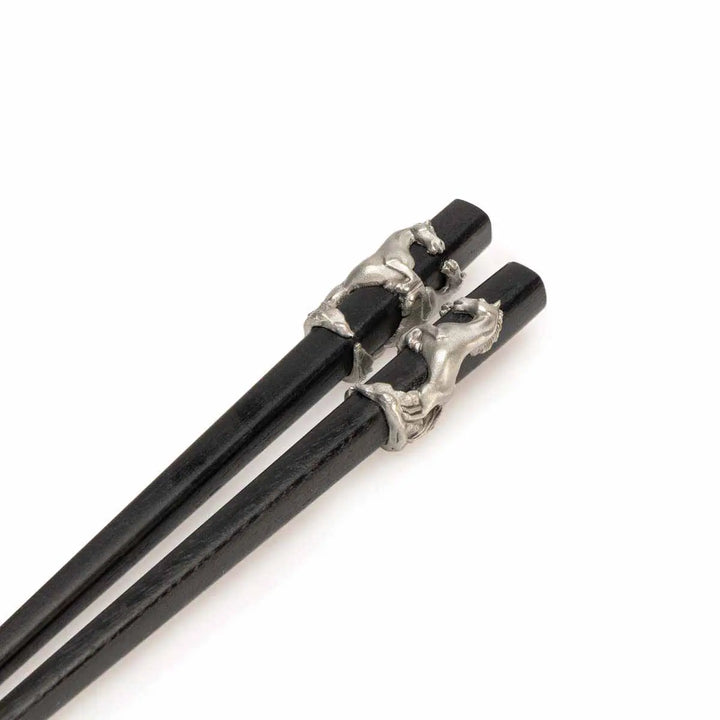 Elegant Royal Selangor 2026 Year of the Horse Chopsticks &amp; Rest Set, featuring polished wooden chopsticks with sculpted pewter horse accents and a pewter chopstick rest in a calm, reclining horse pose, symbolizing strength and grace.