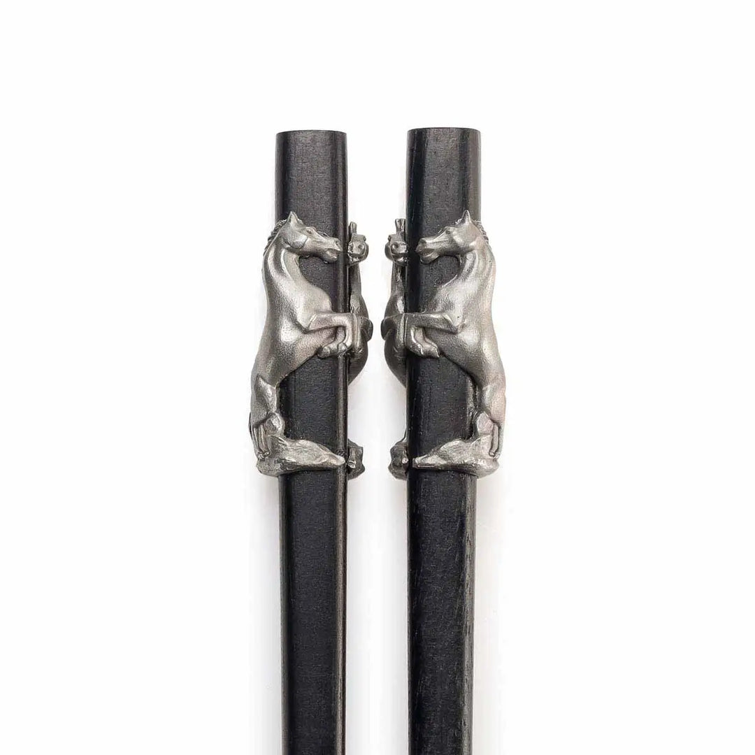 Elegant Royal Selangor 2026 Year of the Horse Chopsticks &amp; Rest Set, featuring polished wooden chopsticks with sculpted pewter horse accents and a pewter chopstick rest in a calm, reclining horse pose, symbolizing strength and grace.