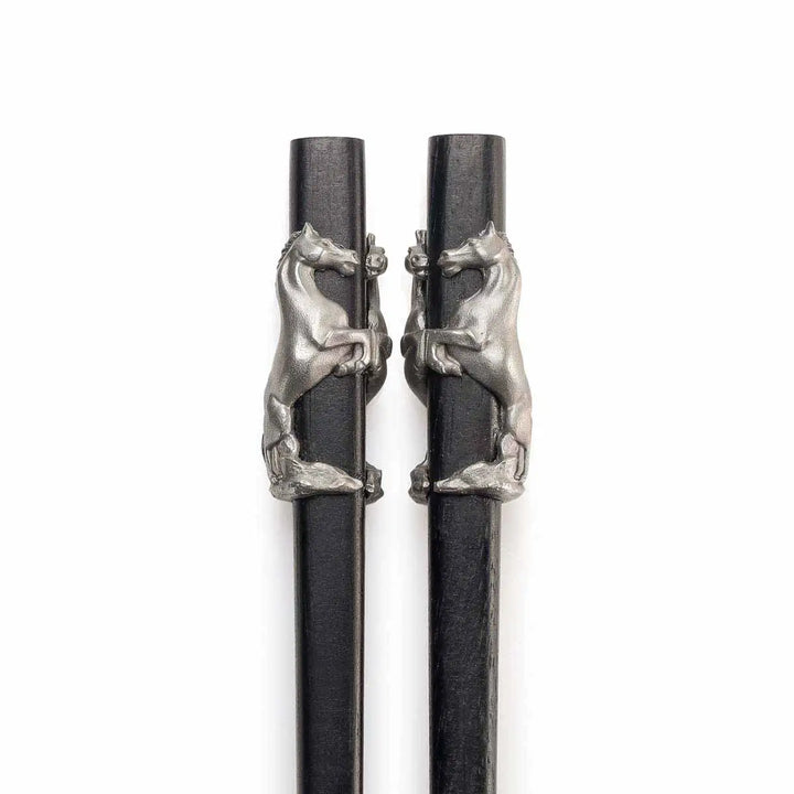 Elegant Royal Selangor 2026 Year of the Horse Chopsticks &amp; Rest Set, featuring polished wooden chopsticks with sculpted pewter horse accents and a pewter chopstick rest in a calm, reclining horse pose, symbolizing strength and grace.