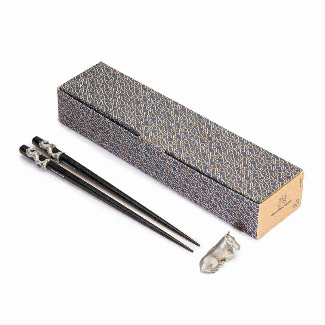 Elegant Royal Selangor 2026 Year of the Horse Chopsticks &amp; Rest Set, featuring polished wooden chopsticks with sculpted pewter horse accents and a pewter chopstick rest in a calm, reclining horse pose, symbolizing strength and grace.