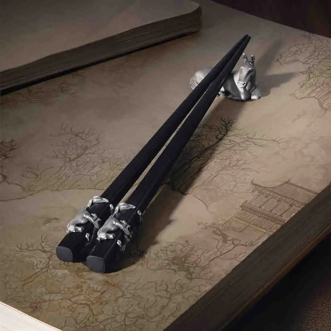 Elegant Royal Selangor 2026 Year of the Horse Chopsticks &amp; Rest Set, featuring polished wooden chopsticks with sculpted pewter horse accents and a pewter chopstick rest in a calm, reclining horse pose, symbolizing strength and grace.