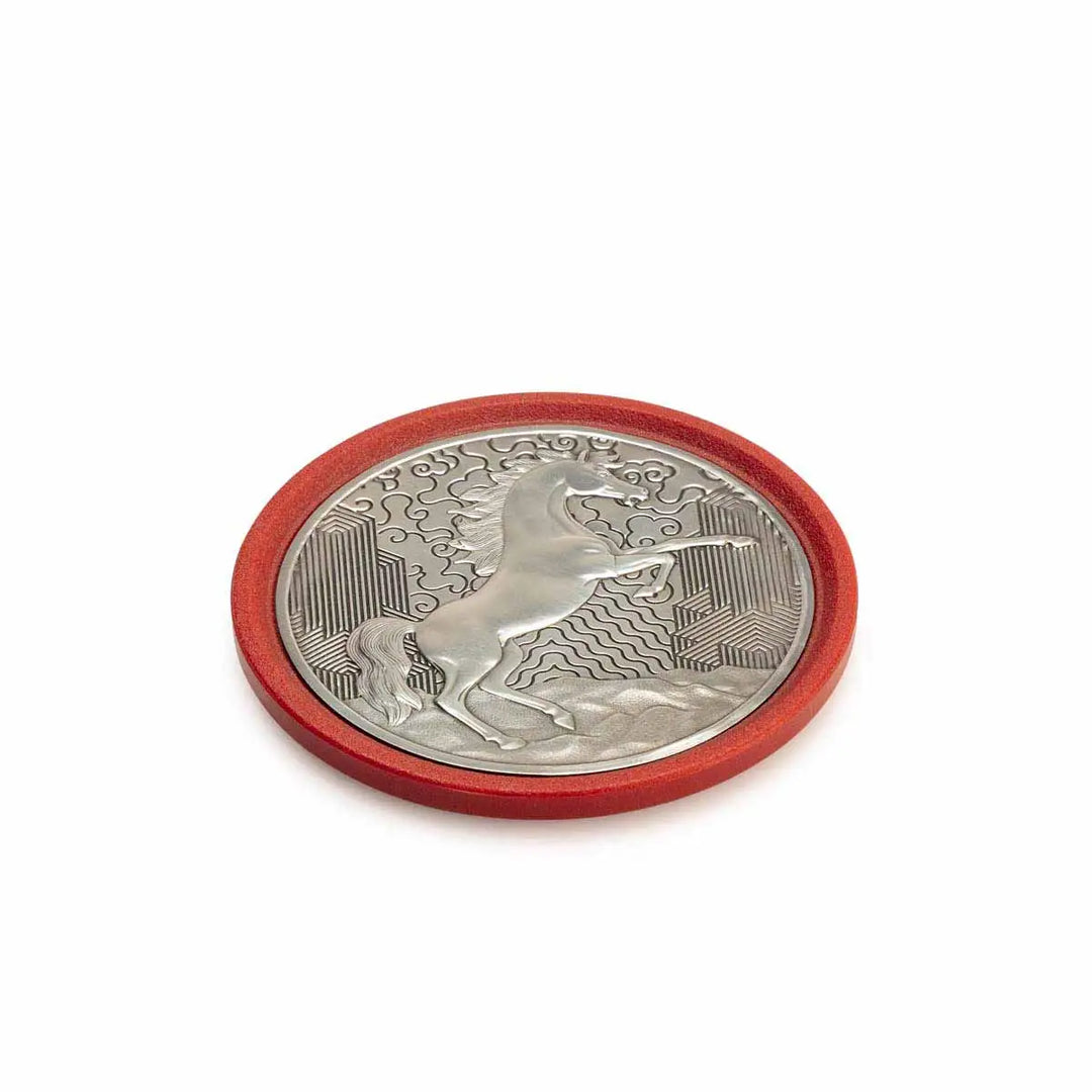 Round pewter coaster with a raised design of a rearing horse, set against a red eco-composite base—symbolizing vitality, energy, and progress for the Year of the Horse.