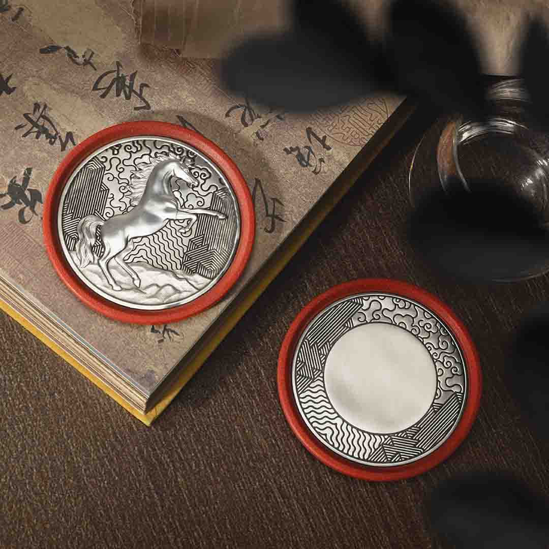 Round pewter coaster with a raised design of a rearing horse, set against a red eco-composite base—symbolizing vitality, energy, and progress for the Year of the Horse.