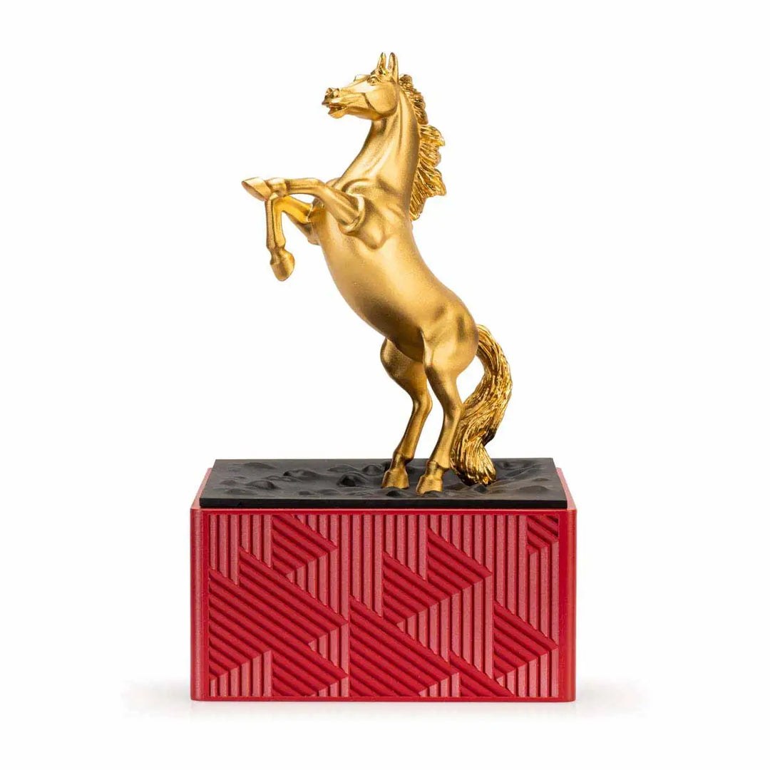 Royal Selangor 2026 Year of the Horse Figurine featuring a rearing 24K gilt horse mounted on a crimson resin base decorated with stylized waves, clouds, and rocks, symbolizing harmony and vitality.