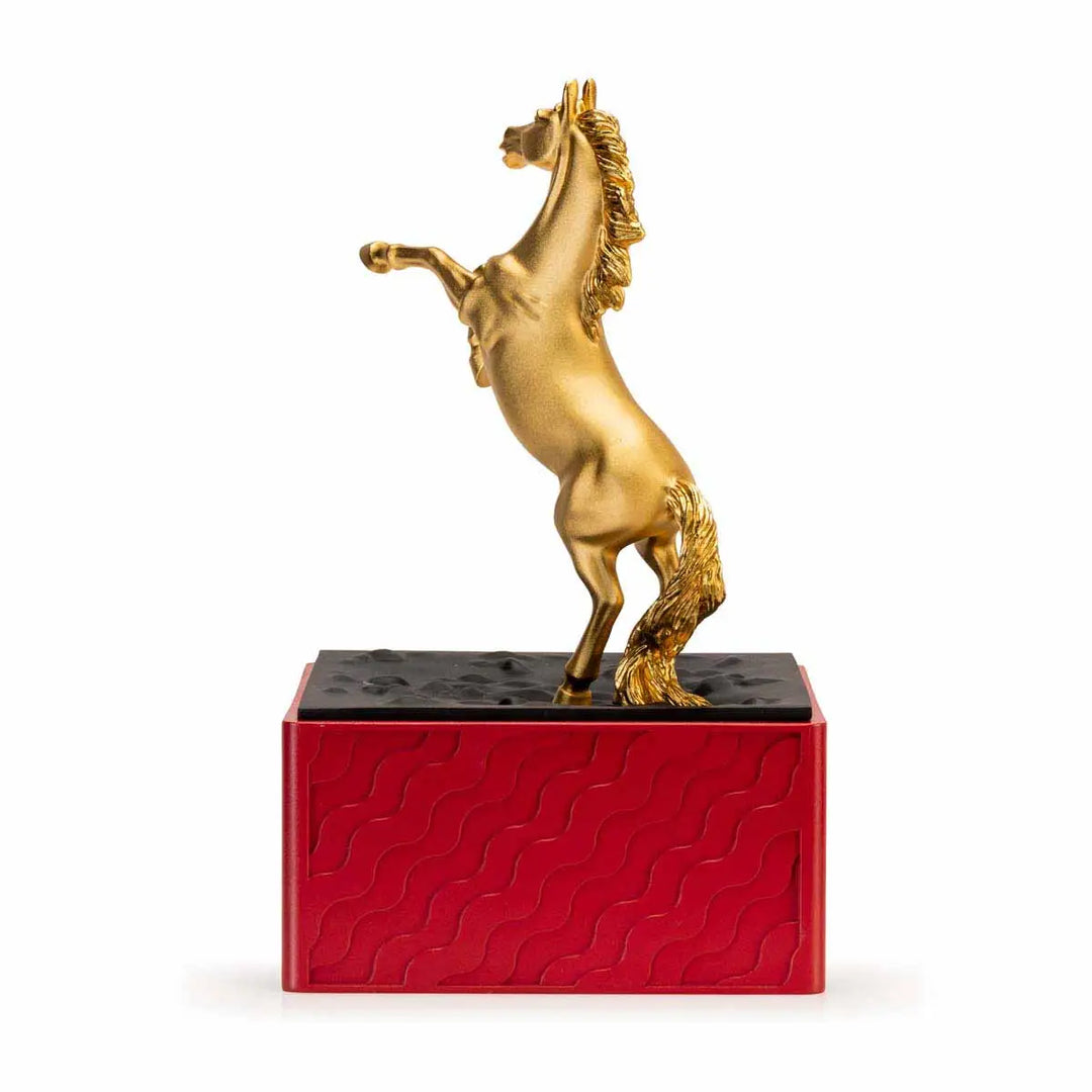 Royal Selangor 2026 Year of the Horse Figurine featuring a rearing 24K gilt horse mounted on a crimson resin base decorated with stylized waves, clouds, and rocks, symbolizing harmony and vitality.