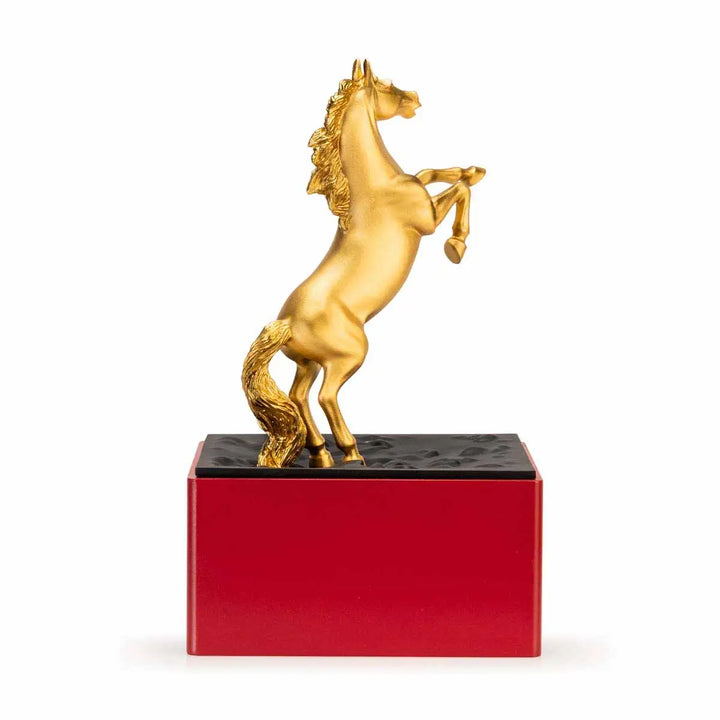 Royal Selangor 2026 Year of the Horse Figurine featuring a rearing 24K gilt horse mounted on a crimson resin base decorated with stylized waves, clouds, and rocks, symbolizing harmony and vitality.