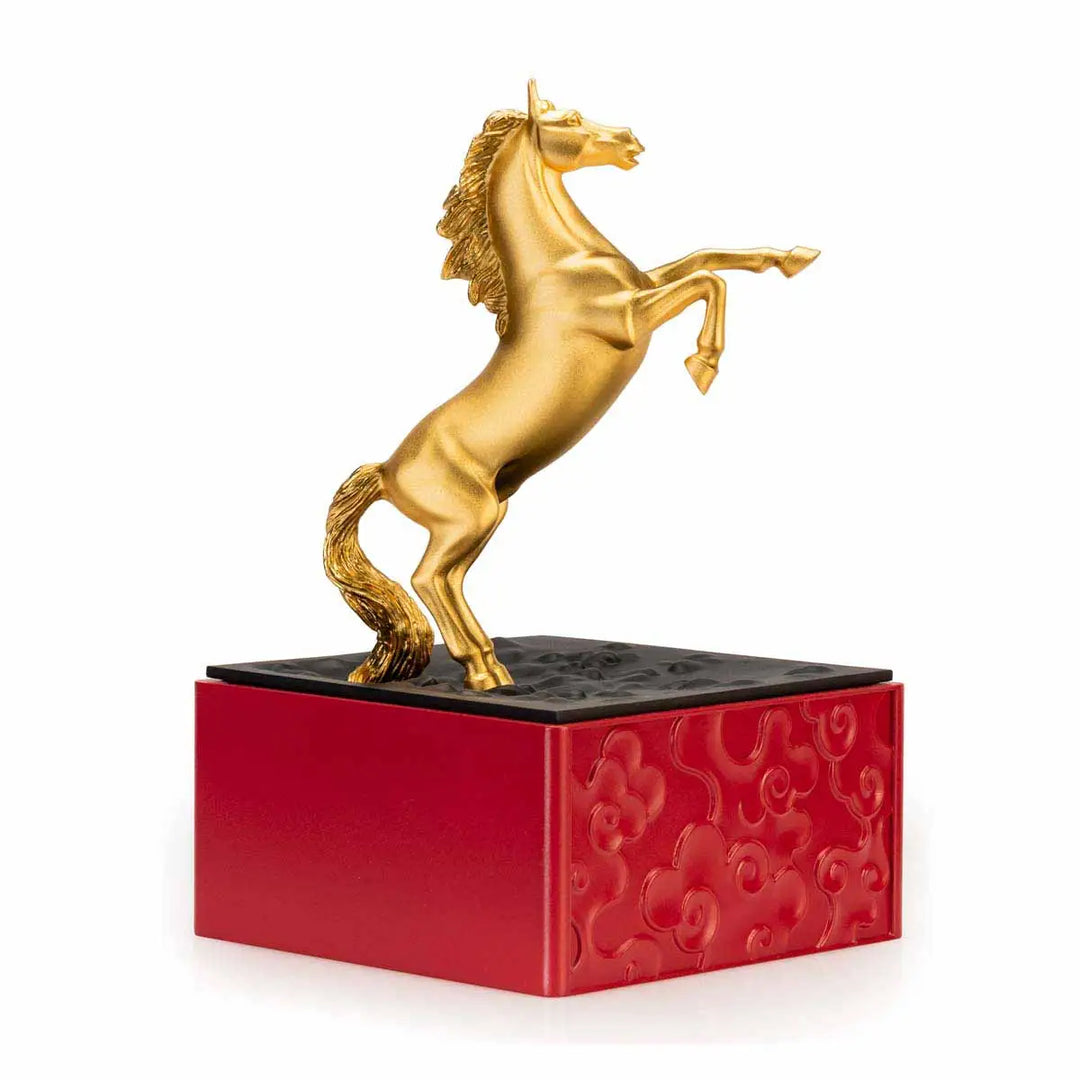 Royal Selangor 2026 Year of the Horse Figurine featuring a rearing 24K gilt horse mounted on a crimson resin base decorated with stylized waves, clouds, and rocks, symbolizing harmony and vitality.