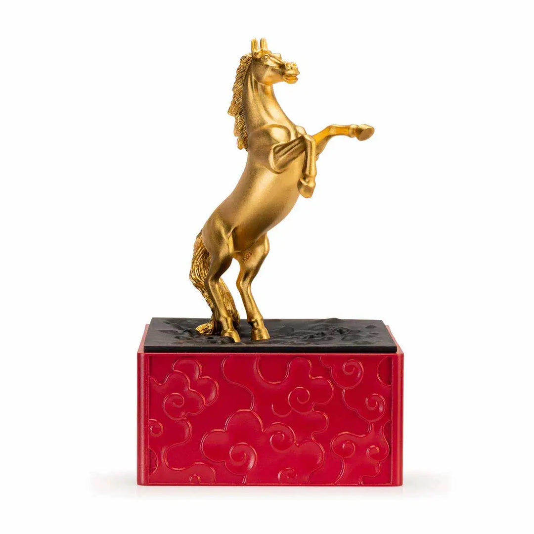 Royal Selangor 2026 Year of the Horse Figurine featuring a rearing 24K gilt horse mounted on a crimson resin base decorated with stylized waves, clouds, and rocks, symbolizing harmony and vitality.