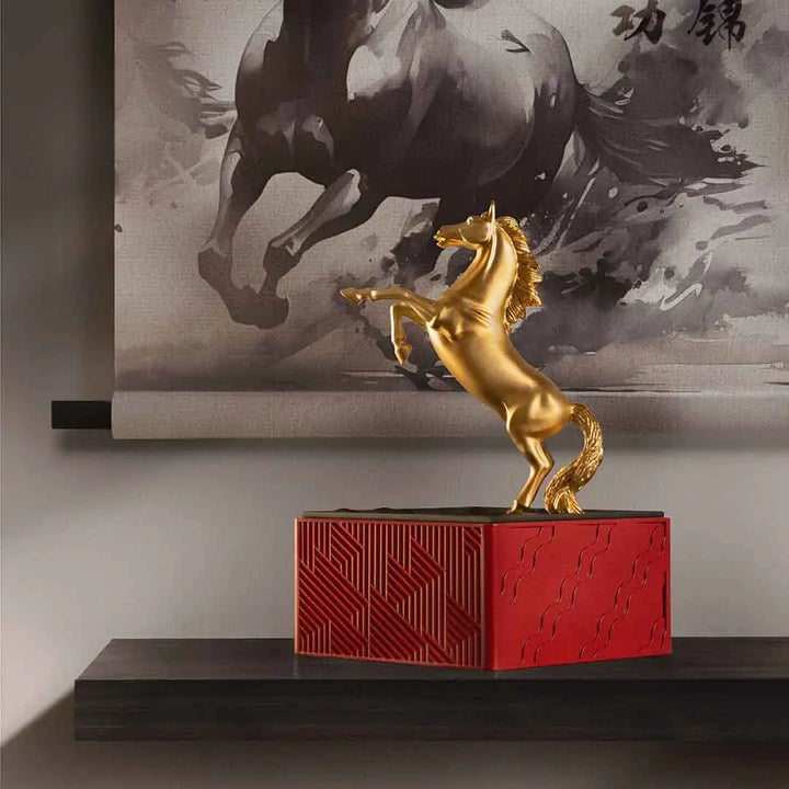 Royal Selangor 2026 Year of the Horse Figurine featuring a rearing 24K gilt horse mounted on a crimson resin base decorated with stylized waves, clouds, and rocks, symbolizing harmony and vitality.