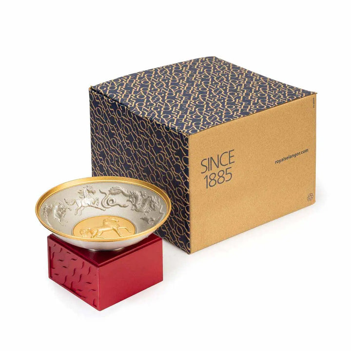 Royal Selangor 2026 Year of the Horse Wealth Bowl featuring a 24K gilt galloping horse at the center medallion, a zodiac frieze around the rim, and a crimson resin base detailed with waves, rocks, and clouds.