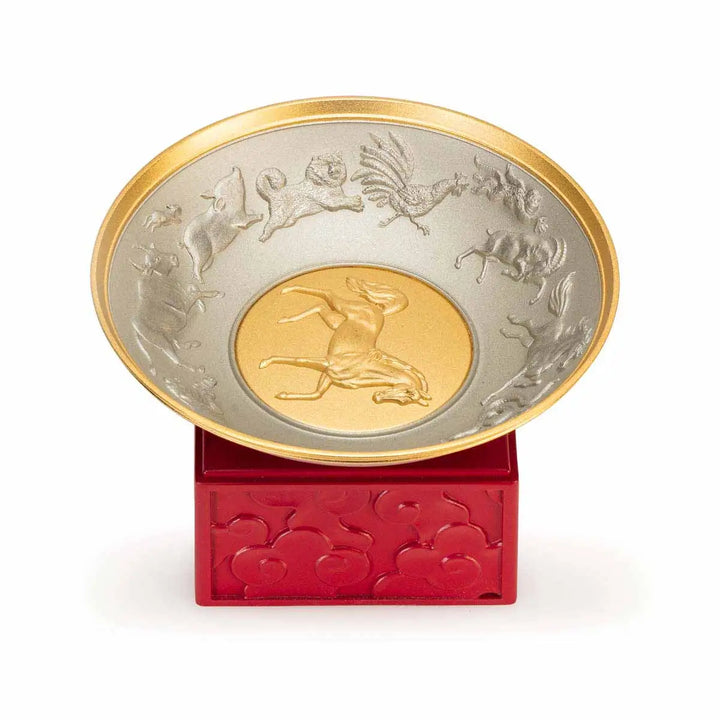 Royal Selangor 2026 Year of the Horse Wealth Bowl featuring a 24K gilt galloping horse at the center medallion, a zodiac frieze around the rim, and a crimson resin base detailed with waves, rocks, and clouds.