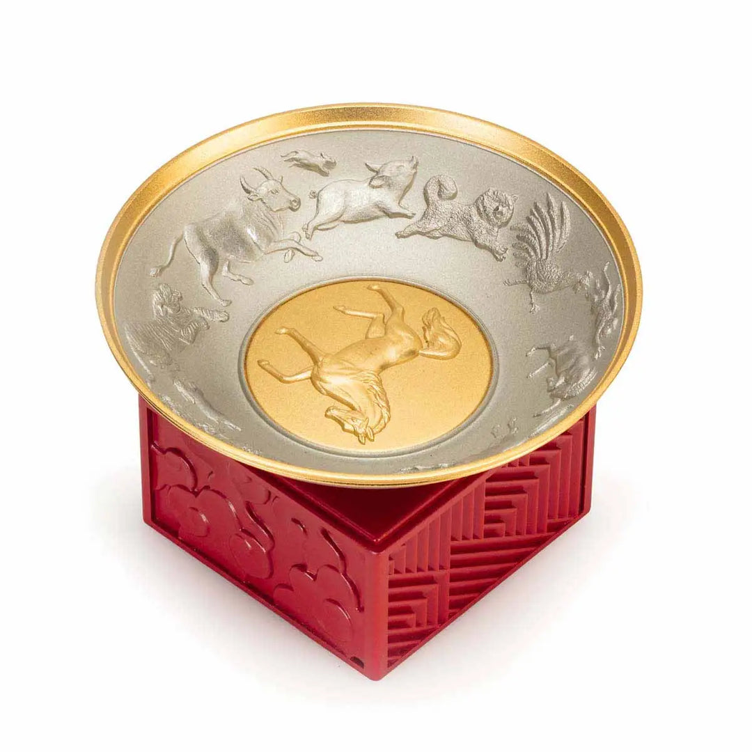 Royal Selangor 2026 Year of the Horse Wealth Bowl featuring a 24K gilt galloping horse at the center medallion, a zodiac frieze around the rim, and a crimson resin base detailed with waves, rocks, and clouds.