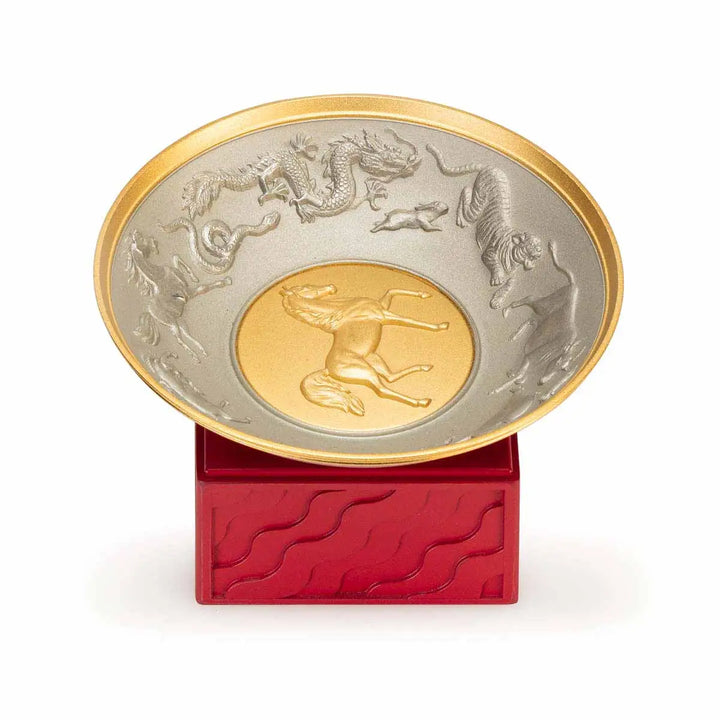 Royal Selangor 2026 Year of the Horse Wealth Bowl featuring a 24K gilt galloping horse at the center medallion, a zodiac frieze around the rim, and a crimson resin base detailed with waves, rocks, and clouds.