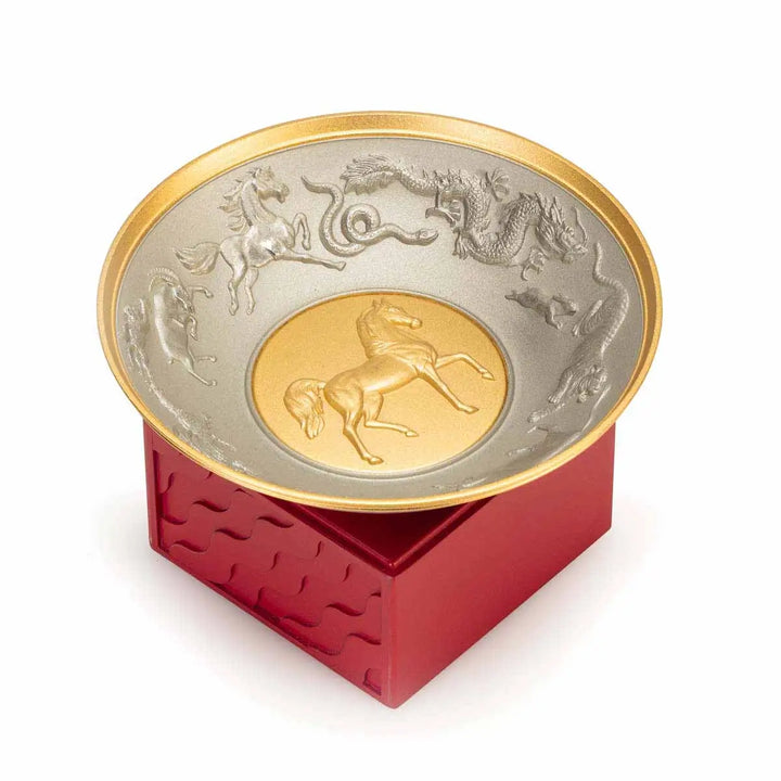 Royal Selangor 2026 Year of the Horse Wealth Bowl featuring a 24K gilt galloping horse at the center medallion, a zodiac frieze around the rim, and a crimson resin base detailed with waves, rocks, and clouds.
