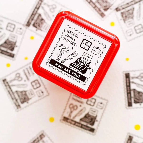 Load image into Gallery viewer, Eric Small Things Pre-Inked Stamp - Postage Stamp featuring a small square postal-themed design by Sanby Japan, displayed with its compact PET casing.
