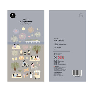 A sheet of decorative stickers featuring illustrations of fireworks, picnic blankets, pizza, drinks, people cycling, dogs, ice cream, and night sky scenes—perfect for journaling and capturing the atmosphere of a summer midnight picnic.