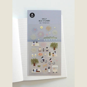 A sheet of decorative stickers featuring illustrations of fireworks, picnic blankets, pizza, drinks, people cycling, dogs, ice cream, and night sky scenes—perfect for journaling and capturing the atmosphere of a summer midnight picnic.